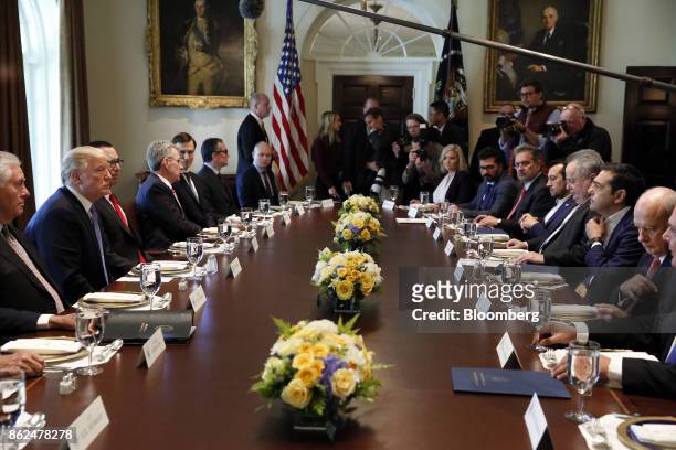 Alexis Tsipras, Greece's prime minister, second right, speaks as U.S. President Donald Trump, second left, listens during a working lunch in the...