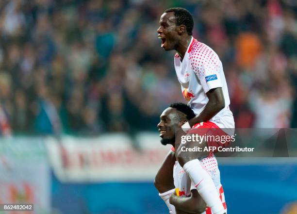 Leipzig´s French forward Jean-Kevin Augustin celebrates after scoring the 3-1 goal with his teammate Portuguese forward Bruma during the Champions...