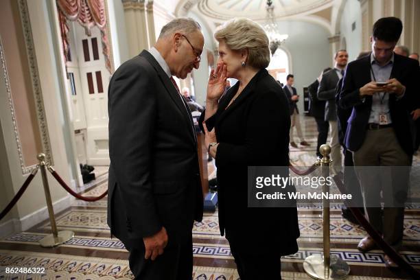 Senate Minority Leader Chuck Schumer confers with Sen. Debbie Stabenow following the weekly Democratic policy luncheon at the U.S. Capitol on October...