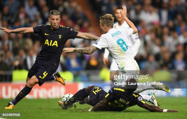 Serge Aurier of Tottenham Hotspur fouls Toni Kroos of Real Madrid and a penalty is awarded during the UEFA Champions League group H match between...
