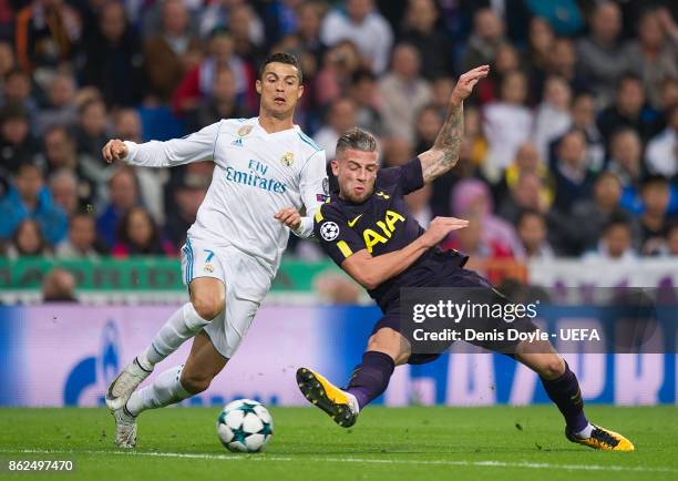 Cristiano Ronaldo of Real Madrid CF is tackled by Toby Alderweireld of Tottenham Hotspur during the UEFA Champions League group H match between Real...