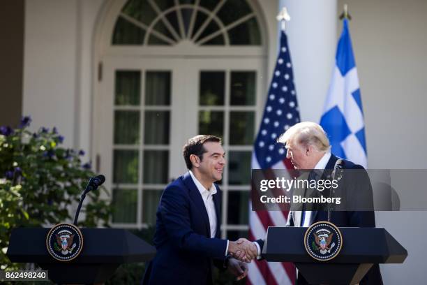 President Donald Trump, right, shakes hands with Alexis Tsipras, Greece's prime minister, sfollowing a joint press conference in the Rose Garden of...