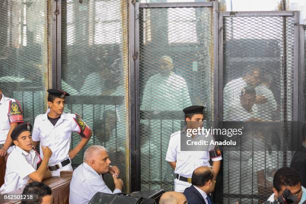 Police officers take security measures during the trial session, known as breaking up the Rabaa el-Adaweya protests case, at Cairo criminal court in...