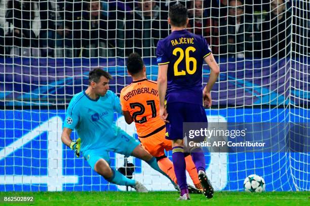 Liverpool's British midfielder Alex Oxlade-Chamberlain scores past Maribor's Slovenian goalkeeper Jasmin Handanovic during the UEFA Champions League...