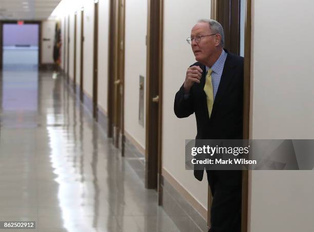 Sen. Lamar Alexander walks out of his office to speak to the media about a possible bipartisan agreement with Democrats to fund key Affordable Care...