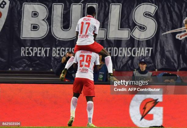 Leipzig´s French forward Jean-Kevin Augustin celebrates after scoring the 3-1 goal with his teammate Portuguese forward Bruma during the Champions...