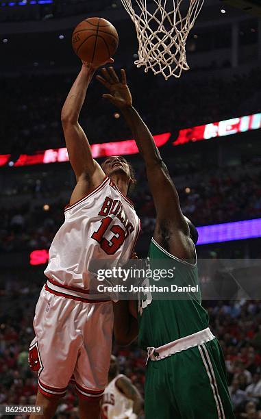 Joakim Noah of the Chicago Bulls knocks the ball away from Kendrick Perkins of the Boston Celtics in Game Three of the Eastern Conference...