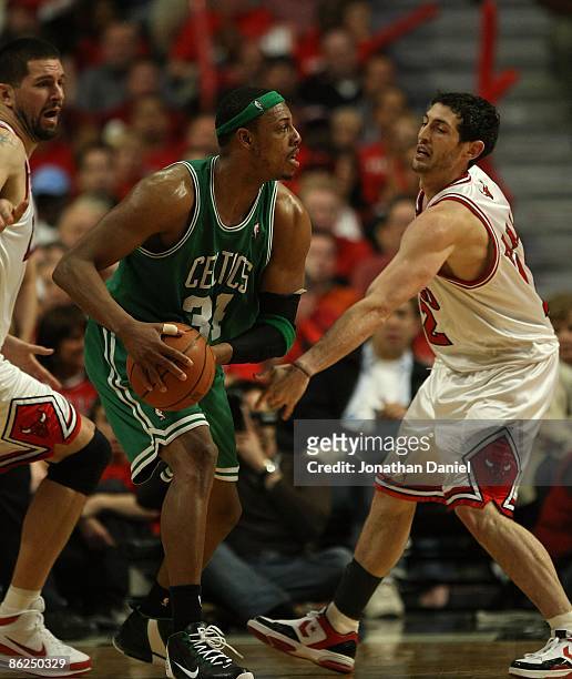 Paul Pierce of the Boston Celtics looks to pass under pressure from Brad Miller and Kirk Hinrich of the Chicago Bulls in Game Three of the Eastern...