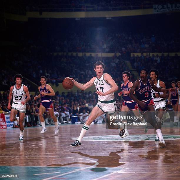 John Havlicek of the Boston Celtics drives up court against the Phoenix Suns during a game in the 1976 NBA Finals played at the Boston Garden in...