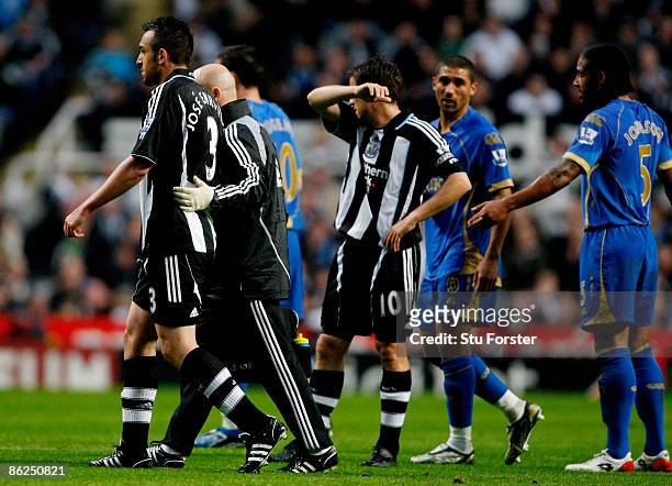 Newcastle player Jose Enrique leaves the field with a hamstring injury during the Premier League match between Newcastle United and Portsmouth at St...