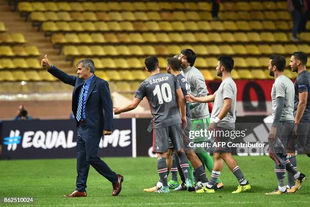 Besiktas' head coach Senol Gunes and Besiktas' players react after winning the UEFA Champions League group stage football match between Monaco and...