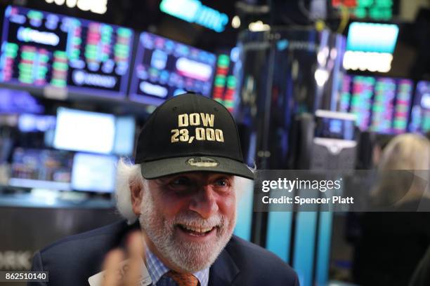 Trader wears a hat reading Dow 23,000 on the floor of the New York Stock Exchange on October 17, 2017 in New York City. The Dow Jones Industrial...