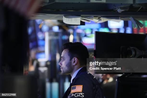 Traders work on the floor of the New York Stock Exchange on October 17, 2017 in New York City. The Dow Jones Industrial average briefly rose to...