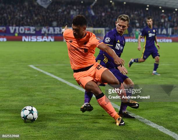 Alex Oxlade-Chamberlain of Liverpool competes with Martin Milec of NK Mariborduring the UEFA Champions League group E match between NK Maribor and...