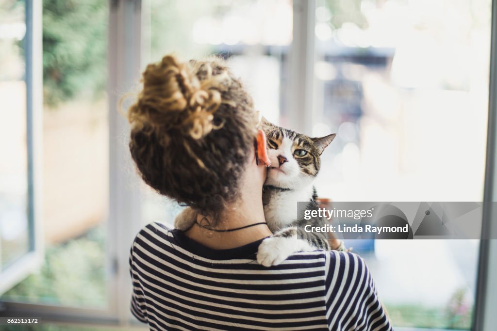 A teenager girl holding her cat