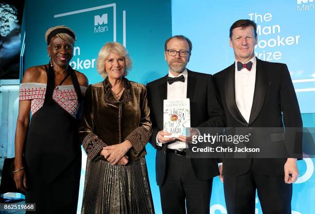 Baroness Lola Young, Camilla Duchess of Cornwall, winning author George Saunders and Man Group CEO Luke Ellis on stage at the Man Booker Prize dinner...