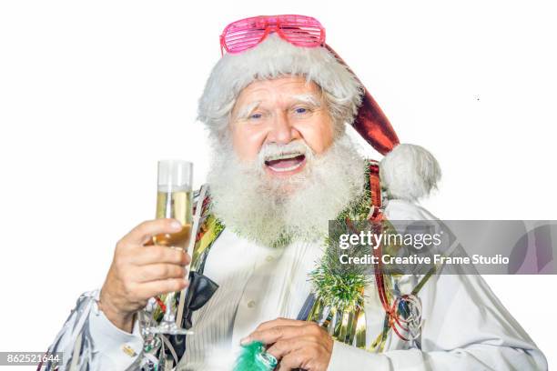 cheerful santa claus celebrating  with a glass of champagne and party favors - serpentin bildbanksfoton och bilder