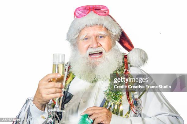 cheerful santa claus celebrating  with a glass of champagne and party favors - christmas truce 個照片及圖片檔