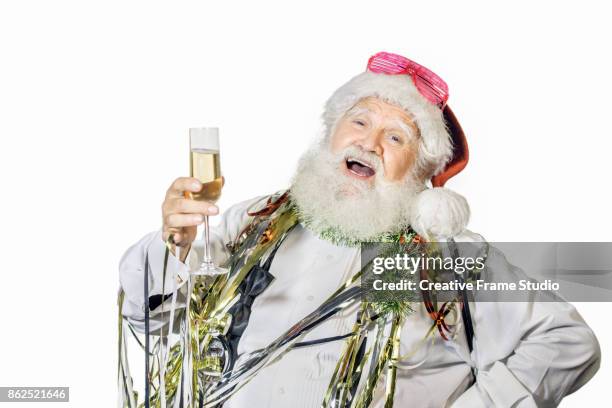cheerful santa claus celebrating and dancing  with a glass of champagne and party favors - serpentin bildbanksfoton och bilder
