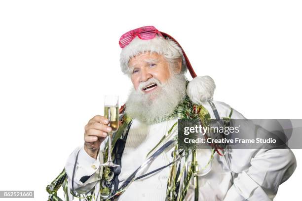 candid santa claus celebrating  with a glass of champagne and party favors - serpentin bildbanksfoton och bilder