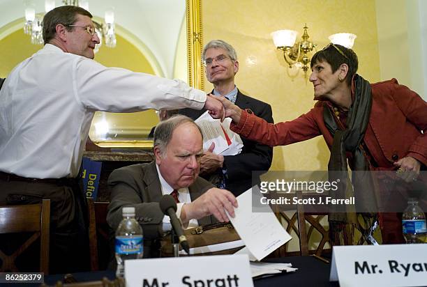 April 27: Senate Budget Chairman Kent Conrad, D-N.D., and Rep. Rosa DeLauro, D-Conn., shake hands as House Budget Chairman John M. Spratt Jr.,...