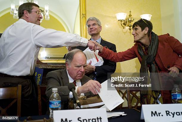 April 27: Senate Budget Chairman Kent Conrad, D-N.D., and Rep. Rosa DeLauro, D-Conn., shake hands as House Budget Chairman John M. Spratt Jr.,...