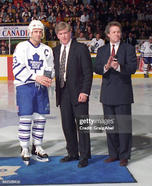 Brian Burke of the NHL and former Leaf Darryl Sittler present Doug Gilmmour of the Toronto Maple Leafs with an award for achieving 1000 points prior...