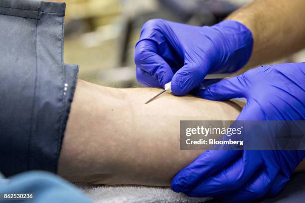 Nurse inserts an intravenous needle into the arm of a donor during a blood drive at Perry Memorial Hospital in Princeton, Illinois, U.S., on...