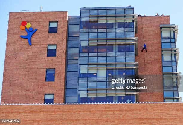 Aurora Police Strategic Response Team member Jeff Jacobs, dressed as Captain America rappels from the rooftop of Childrens Hospital Colorado to...