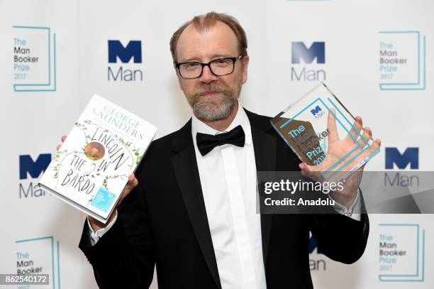 Winning author George Saunders is pictured with his award at The Guildhall during the Man Booker Prize winner announcement photocall, on October 17,...