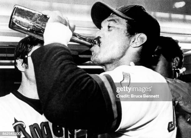 Reggie Jackson of the California Angels drinks champagne in the locker room after the Angels defeated the Texas Rangers to clinch the American League...