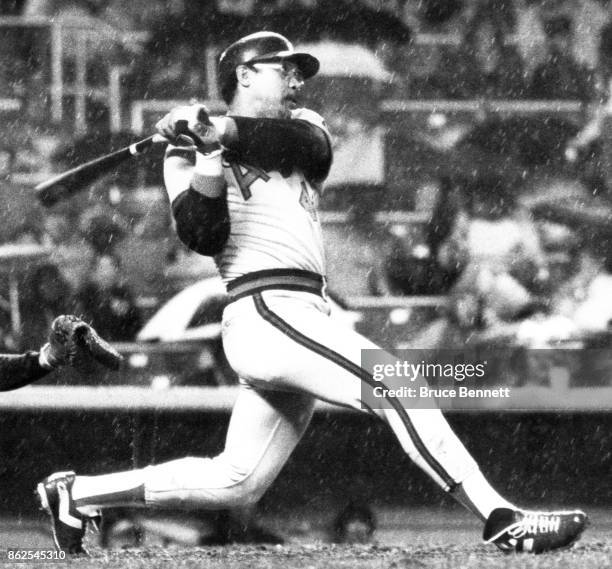 Reggie Jackson of the California Angels hits a homerun as rain falls during an MLB game against the New York Yankees on April 27, 1982 at Yankee...