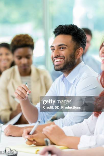 young male business student laughs during class lecture - college student diverse stock pictures, royalty-free photos & images