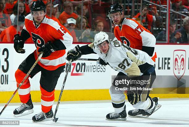 Sidney Crosby of the Pittsburgh Penguins skates against Jeff Carter and Joffrey Lupul of the Philadelphia Flyers during Game Six of the Eastern...