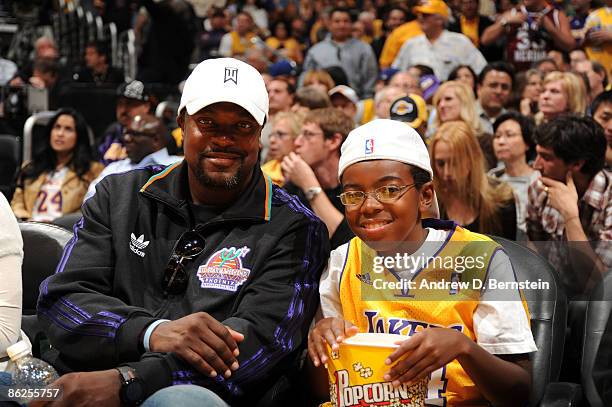 Comedian Chris Tucker and son, Destin watch Game Five of the Western Conference Quarterfinals between the Utah Jazz and the Los Angeles Lakers during...