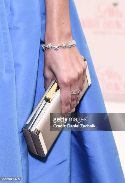 Camilla Belle, accessories detail, poses during the launch of Love & White Diamonds Fragrance at Academy Mansion on October 17, 2017 in New York City.