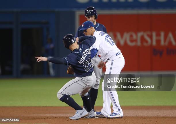 Ryan Goins of the Toronto Blue Jays turns a double play at second base which would be reversed upon video replay review in the seventh inning during...