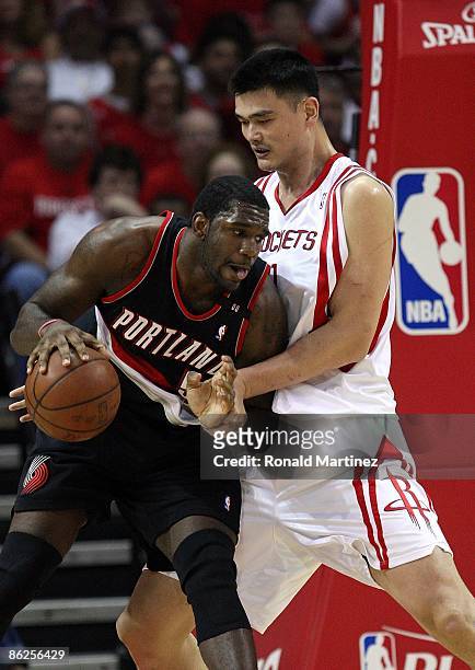 Center Greg Oden of the Portland Trail Blazers dribbles the ball against Yao Ming of the Houston Rockets in Game Four of the Western Conference...