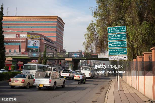 street sign in erbil to various cities in iraq - baghdad stock pictures, royalty-free photos & images