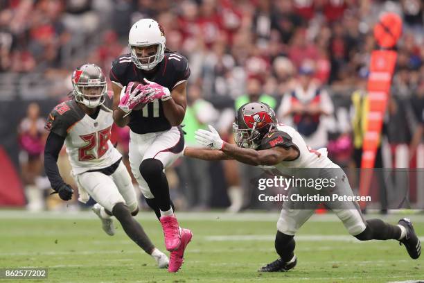 Wide receiver Larry Fitzgerald of the Arizona Cardinals runs with the football after a reception past cornerback Vernon Hargreaves of the Tampa Bay...