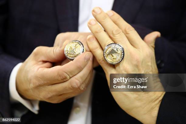 Championship rings are seen on the hands of team owners Joe Lacob and Peter Guber during their NBA game at ORACLE Arena on October 17, 2017 in...