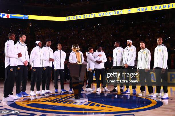 The Golden State Warriors stand during their 2017 NBA Championship ring ceremony prior to their NBA game against the Houston Rockets at ORACLE Arena...