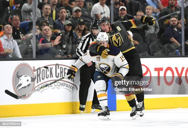 Reilly Smith of the Vegas Golden Knights hits Jake McCabe of the Buffalo Sabres as they chase the puck in the second period of their game at T-Mobile...