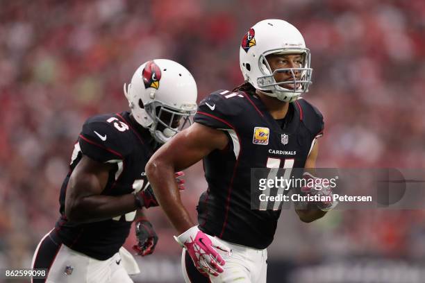 Wide receiver Larry Fitzgerald of the Arizona Cardinals and Jaron Brown step up to the line during the first half of the NFL game against the Tampa...