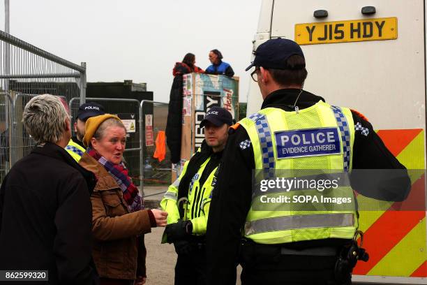 Female protestor pleads with police for food and water to be passed to two Anti-Fracking protestors who have locked themsleves onto a wooden tower to...