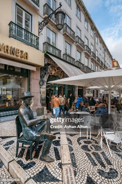 statue of fernando pessoa sitting at a table at cafe brasileira,lisbon,portugal - fernando pessoa stock pictures, royalty-free photos & images