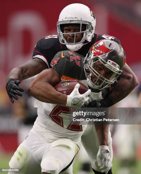 Running back Doug Martin of the Tampa Bay Buccaneers rushes the football past strong safety Antoine Bethea of the Arizona Cardinals during the second...