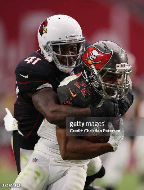 Running back Doug Martin of the Tampa Bay Buccaneers rushes the football past strong safety Antoine Bethea of the Arizona Cardinals during the second...