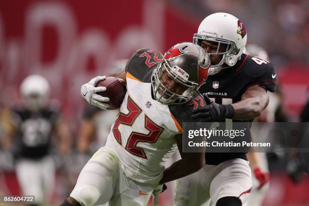 Running back Doug Martin of the Tampa Bay Buccaneers rushes the football past strong safety Antoine Bethea of the Arizona Cardinals during the second...