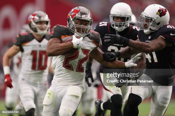 Running back Doug Martin of the Tampa Bay Buccaneers rushes the football past strong safety Antoine Bethea of the Arizona Cardinals during the second...